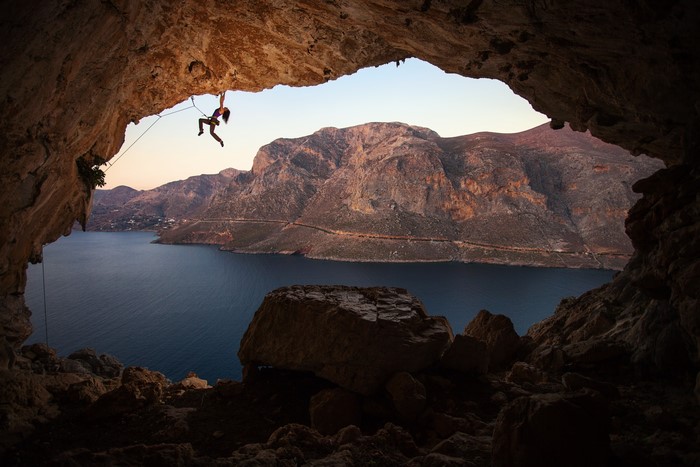 4K Climber in Cave overlooking Bay in Greece