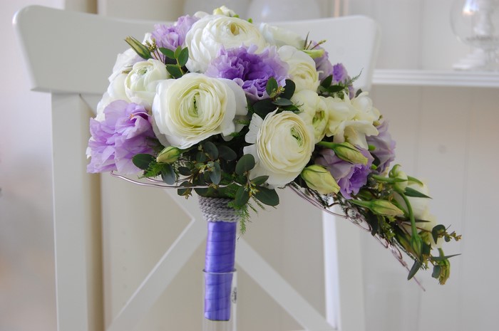 White and purple bridal bouquet with ranunculus and eustoma
