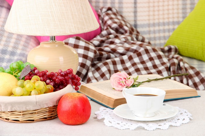 Still-life with fruit, book, coffee, and lamp