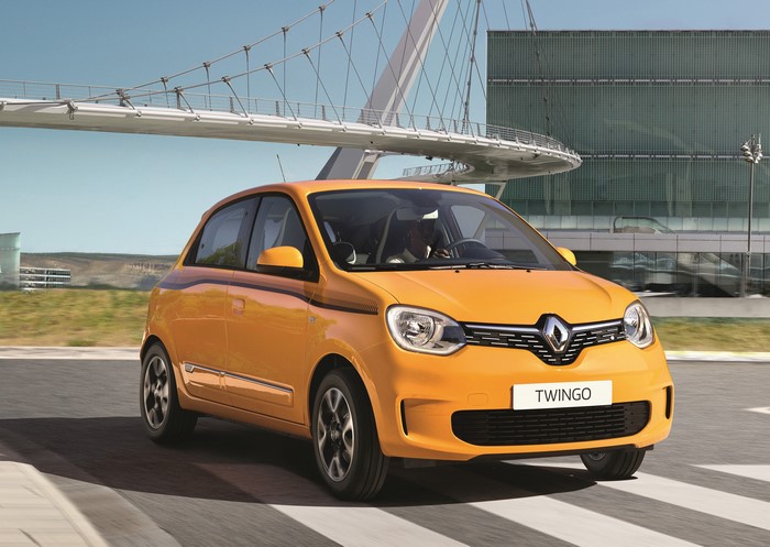 Yellow Renault Twingo driving on road