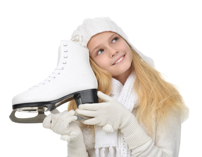 Girl in winter clothes holding an ice skate