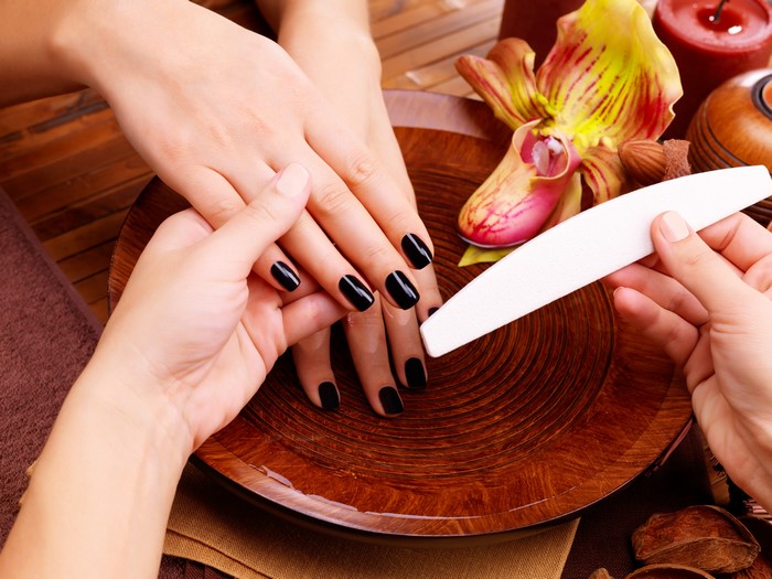 Manicure with black nails and nail file