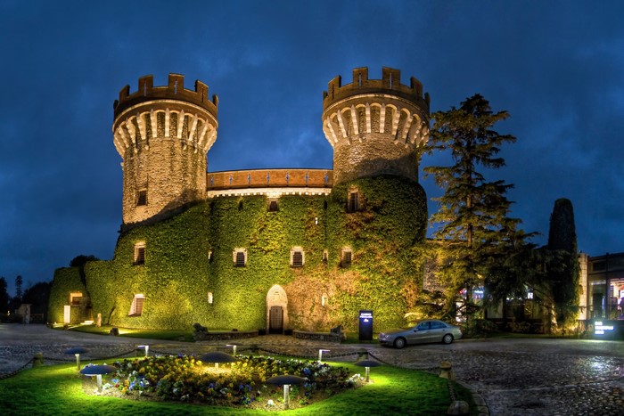 Castell Peralada castle at night with ivy and lights