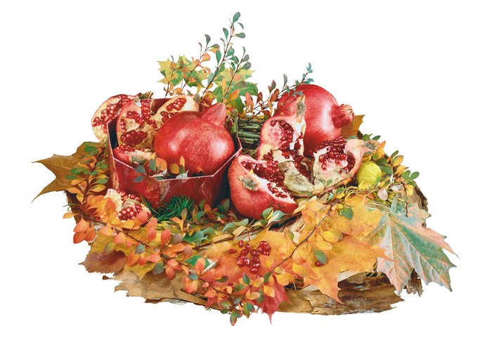 Pomegranates and autumn leaves in a basket