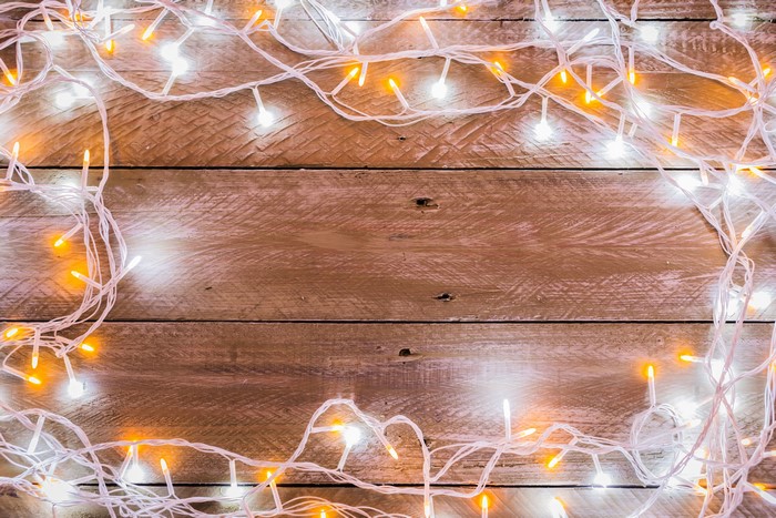 Christmas fairy lights on wood planks