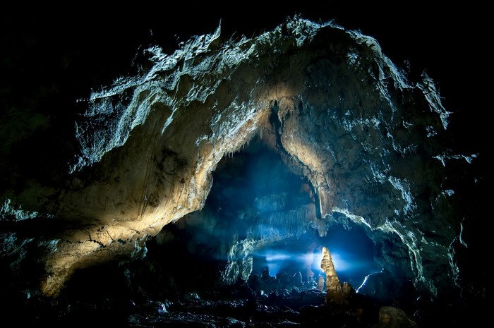 Interior of a large cave with stalactites and stalagmites