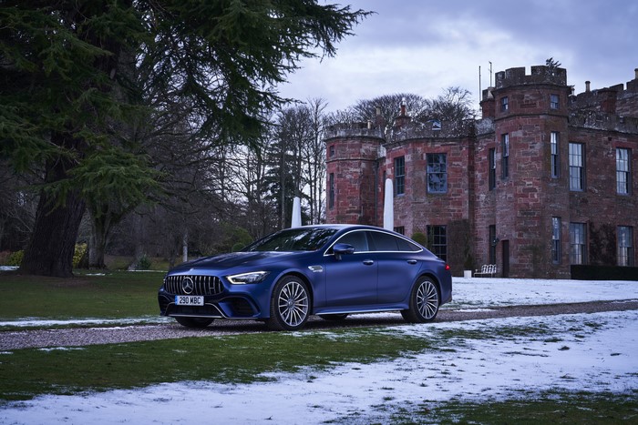 Blue Mercedes-Benz AMG GT 63 S 4-Door Coupe in front of castle