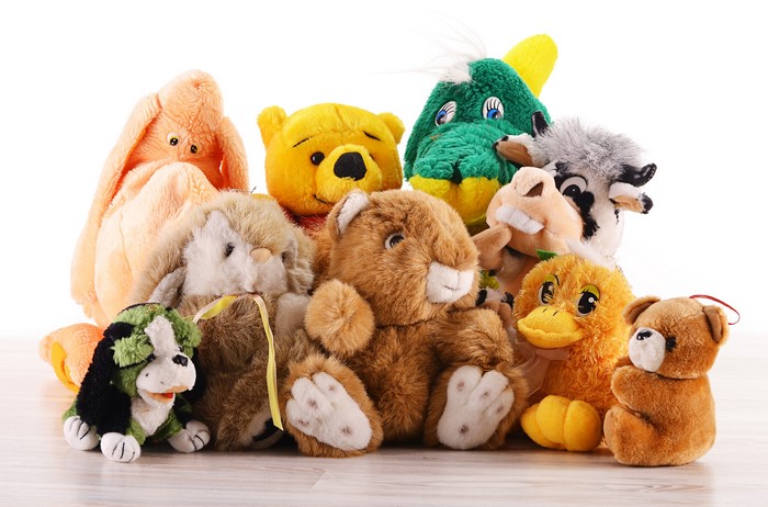 Collection of stuffed animals including teddy bears and a dog