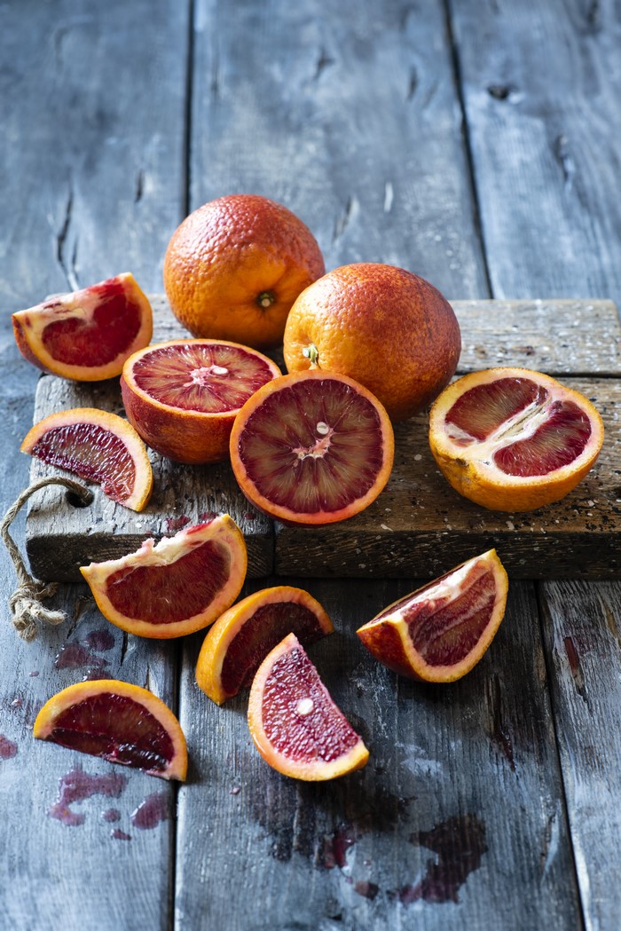 Blood oranges on a wooden cutting board