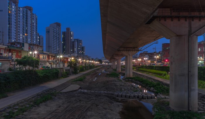 Apartment buildings and houses along a canal at dusk