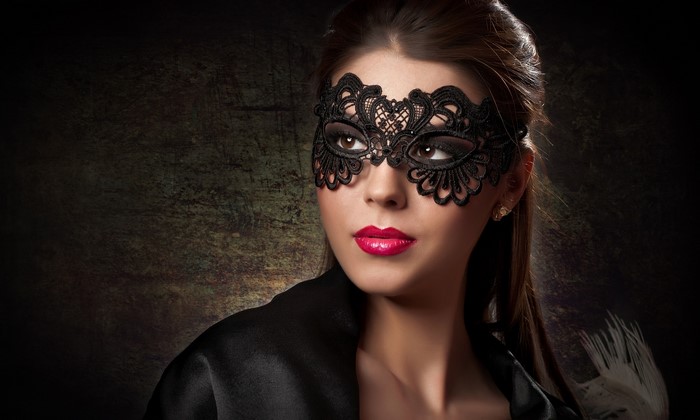 Woman wearing a black lace mask and red lipstick