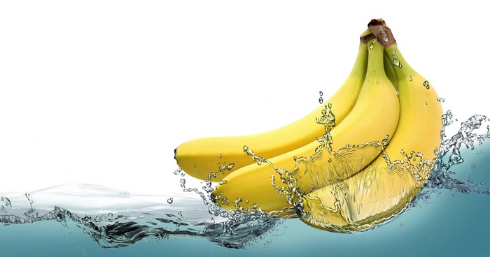 Bananas splashing into water