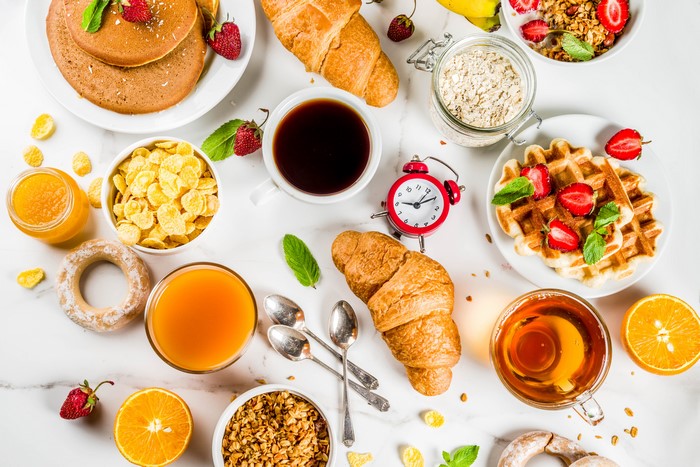 Breakfast spread with coffee, tea, pastries, and fruit