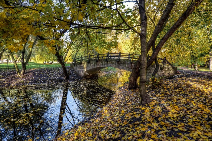 Stone bridge over a river in Ekaterinhof Park, St. Petersburg during autumn