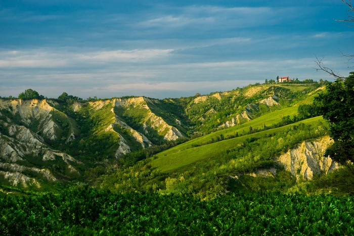 Rolling green hills and eroded landscape in Brisighella, Italy