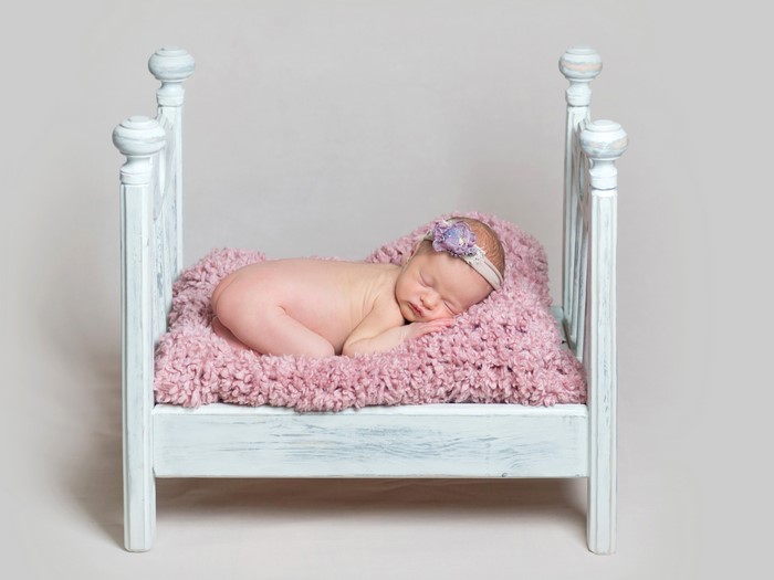 Infant sleeping in a small bed