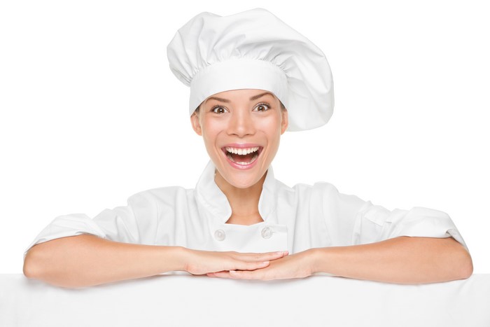 Chef with chef hat behind a white board
