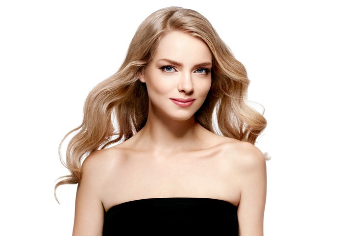 Blonde woman with wavy hair on white background