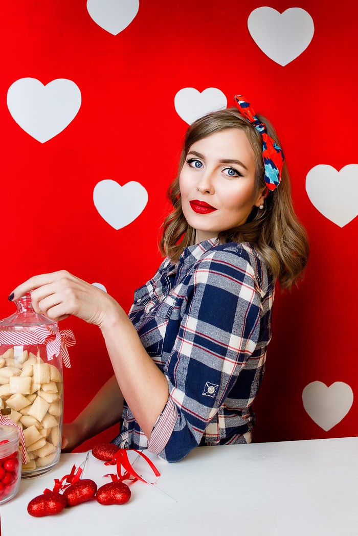 Woman in plaid shirt with candy and hearts
