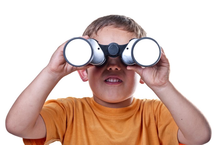 Boy looking through binoculars