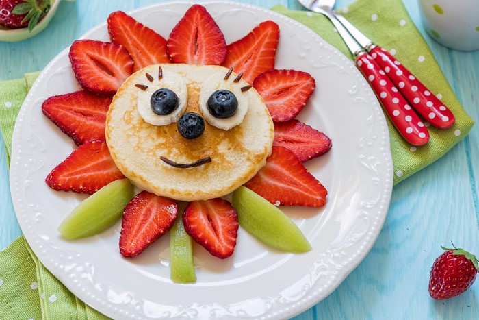 Pancake sun with strawberries and blueberries on a plate
