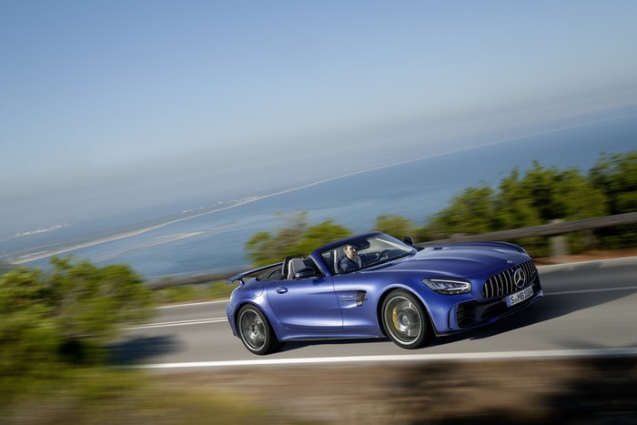 Blue Mercedes-Benz GT R AMG Cabriolet driving on a coastal road