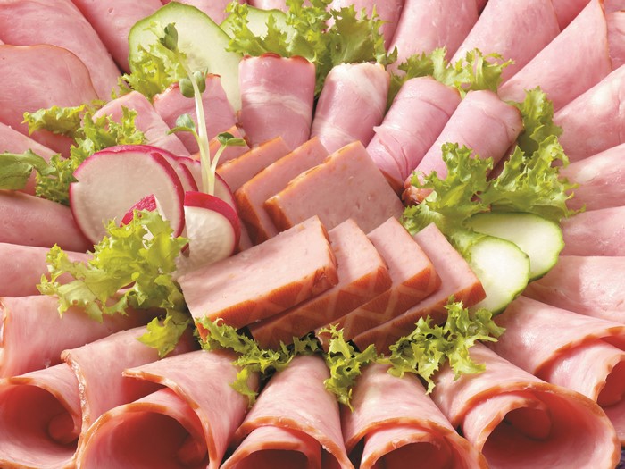 Assortment of sliced meats and vegetables