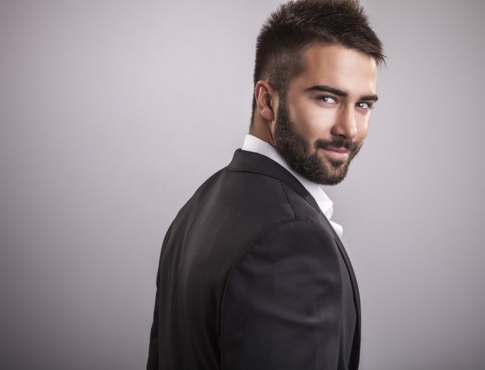 Man with beard wearing a suit and white shirt