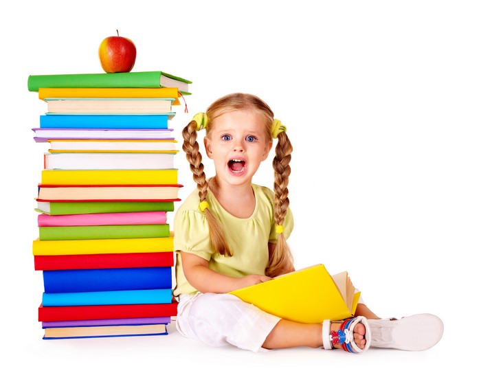 Little girl with stack of books and apple