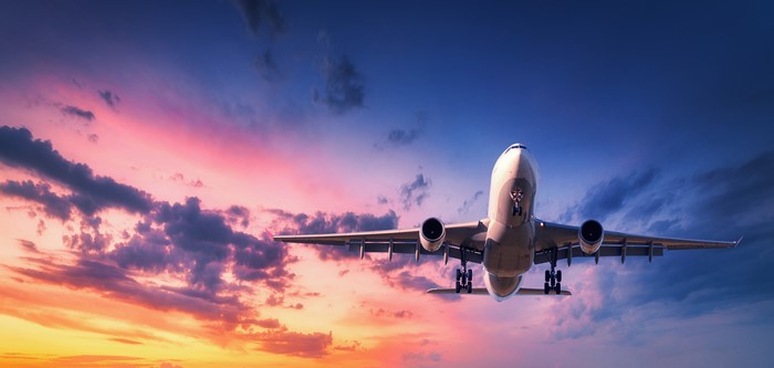 4K Airplane Flying Through Sunset Sky