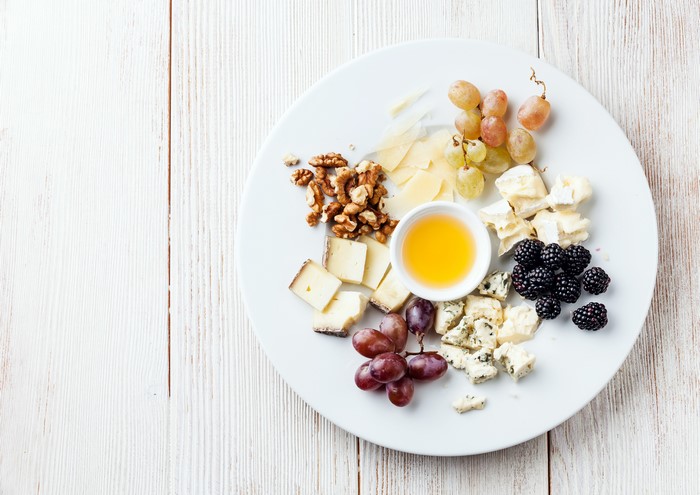 Cheese, Nuts, Grapes, Blackberry, and Honey on a Plate