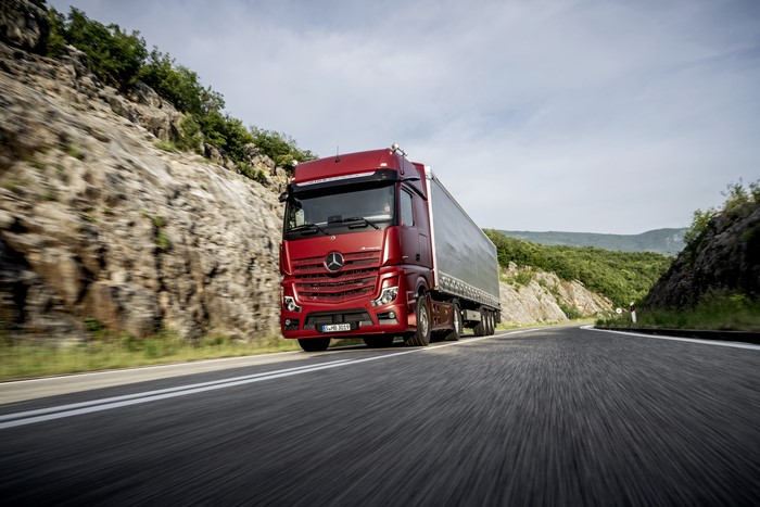 Red Mercedes-Benz Actros Truck on a Mountain Road
