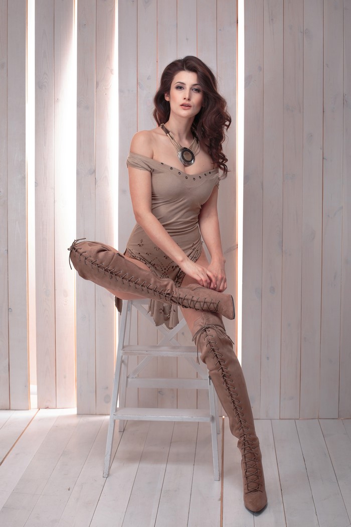 Woman with brown hair wearing thigh-high boots
