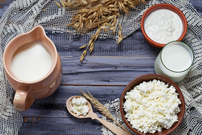Dairy products and oats on wooden planks