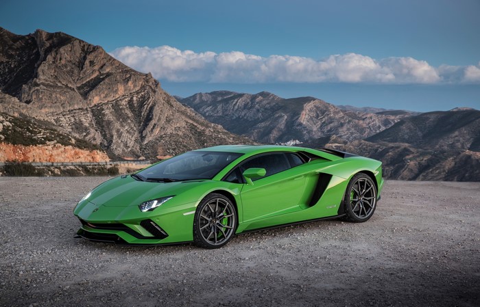 Green Lamborghini Aventador S on a mountain road