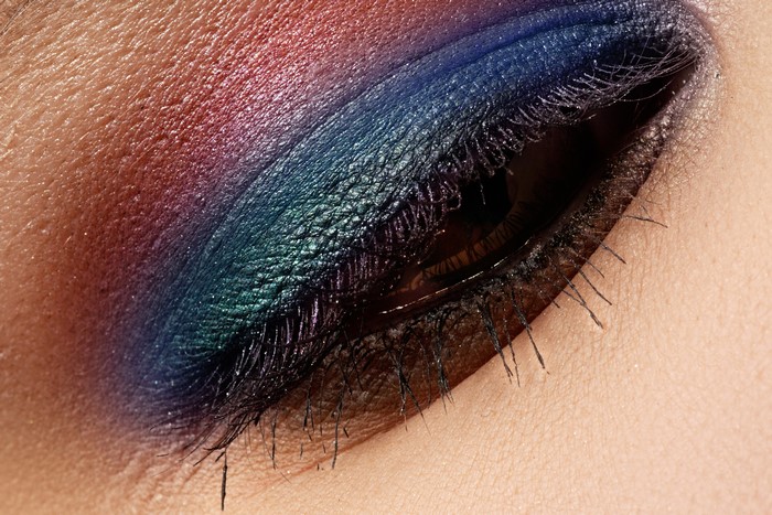 Macro shot of eye makeup with blue and red eyeshadow