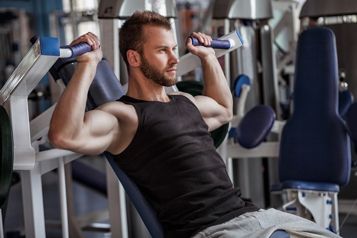 Man working out on a shoulder press machine