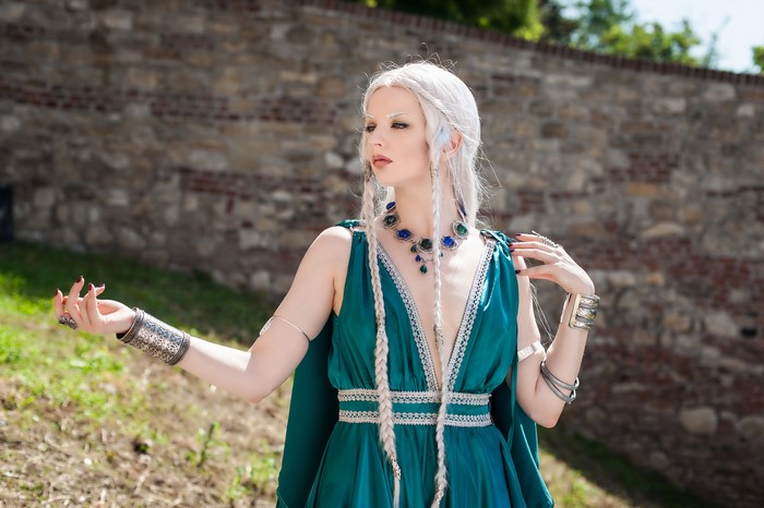 Woman with white hair and elaborate jewelry