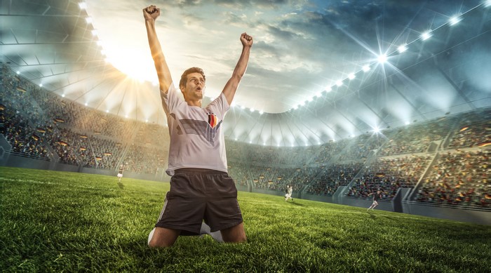 Soccer player celebrating a goal in a stadium