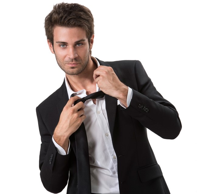 Man in suit adjusting bow tie