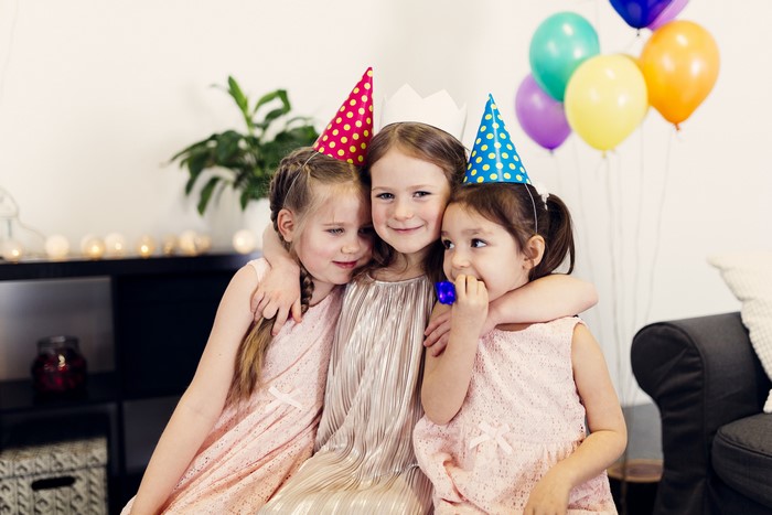 Three little girls celebrating a birthday