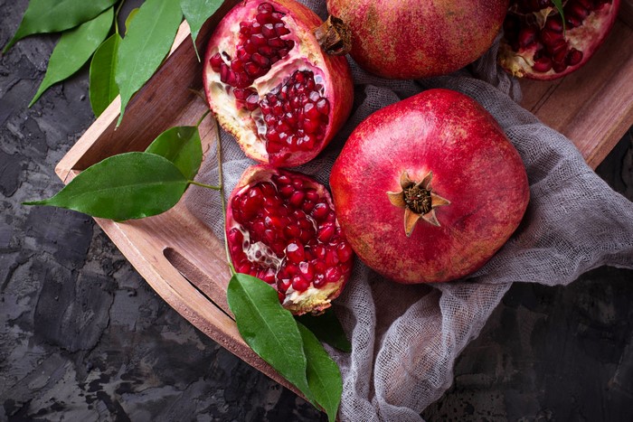 Pomegranates on a wooden tray