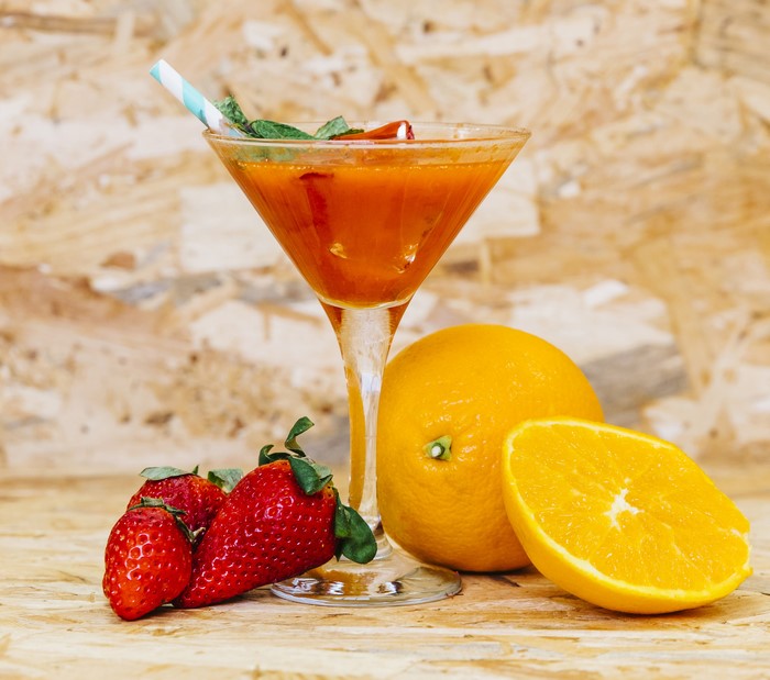 Orange and strawberry cocktail with mint and cinnamon