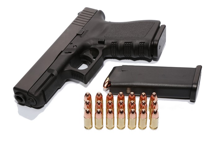 Black pistol with magazine and bullets