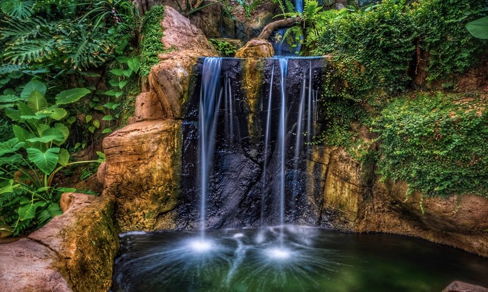 Waterfall cascading over rocks with lush greenery