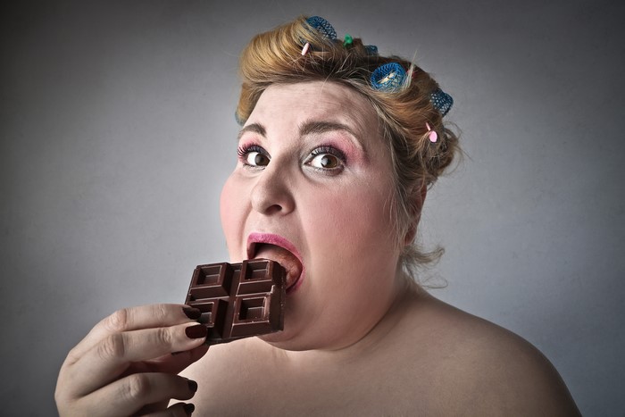 Woman eating chocolate bar