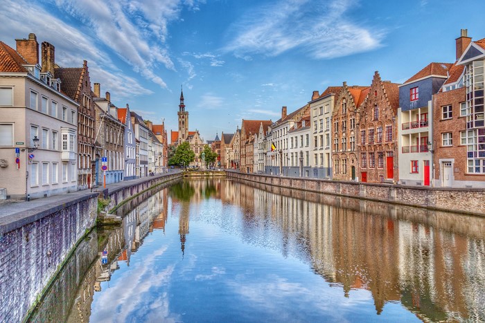 Bruges Canal with historic houses and tower