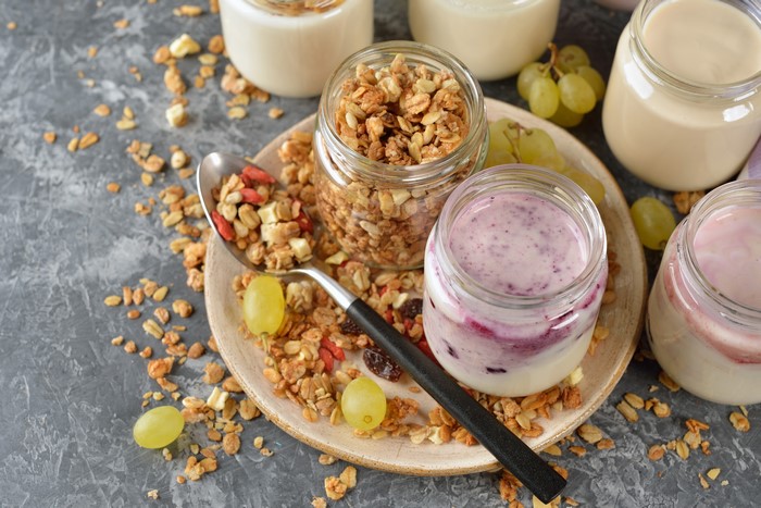 Yogurt and Muesli in Jars with Spoon and Grapes