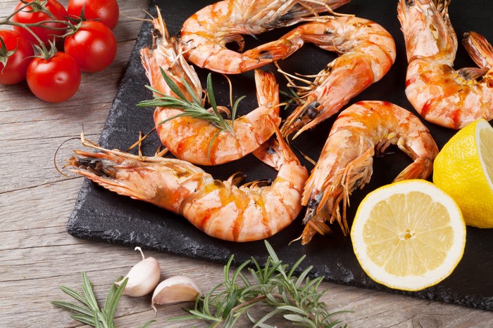 Shrimp with Lemons, Garlic, and Tomatoes on Wood