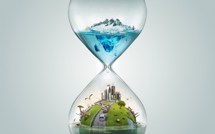 Hourglass with melting ice and city